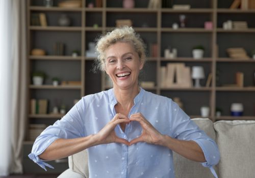 Smiling,Mature,Woman,Looking,At,Camera,Pose,,Show,Symbol,Of